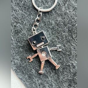 Silver toned robot keychain dangly legs and arms